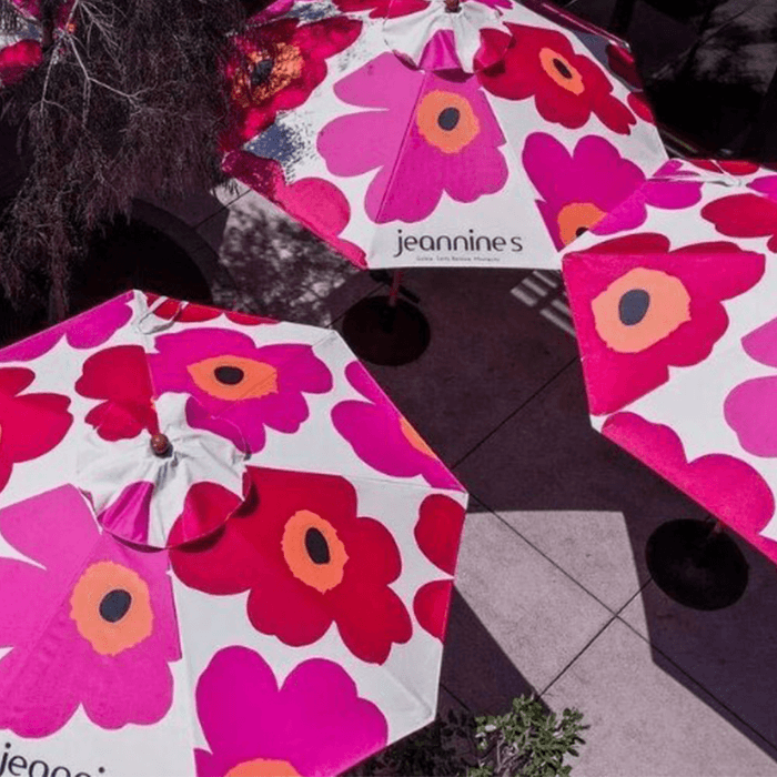 Custom printed umbrellas with vibrant floral patterns using UV digital printing, ideal for high-resolution branding in commercial outdoor environments.